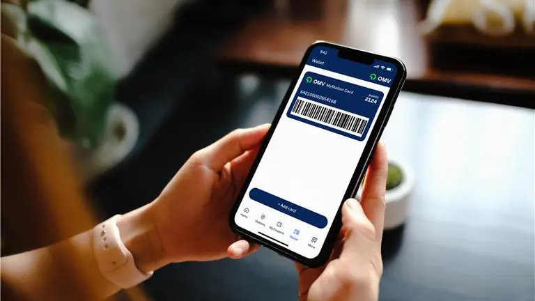 hands holding a phone with the OMV MyStation App open