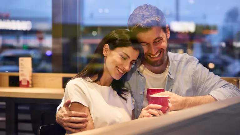 couple in OMV station with coffee